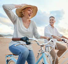 Photo of a couple riding bikes. Links to Gifts of Cash, Checks, and Credit Cards page.
