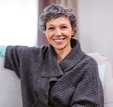 Photo of lady sitting on couch. Links to Closely Held Business Stock page.