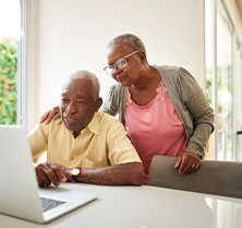 Photo of couple at computer. Links to Gifts That Protect Your Assets page.